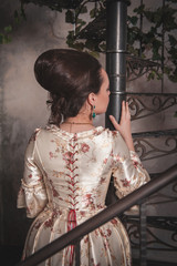 Beautiful woman in historic medieval dress. Back pose
