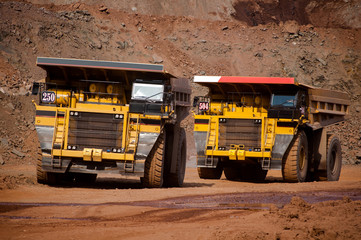 shipping. mining, delivery, transportation, loading, dump truck, truck, huge, heavy. Mining dump truck transports rock, iron ore along the side of the quarry.