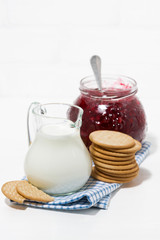 jug of milk, cookies and cranberry jam, vertical