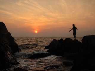 fishermen silhouette at sunset
