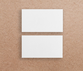 Mockup of two horizontal business cards at brown paper background.