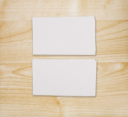 Mockup of two horizontal business cards at light wooden background.