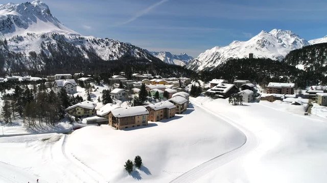 Winter season in Engadine, village of Maloja. Aerial view with drone