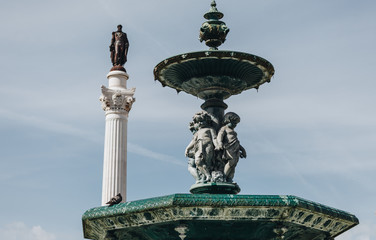 Fototapeta premium View if the bronze fountain in baroque style in Rossio Square Lisbon, Portugal.
