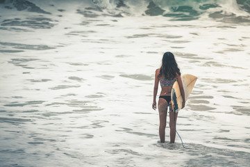 Surfer with surfboard gonna to surf spot, walk near beach.