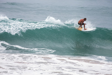 Surfer on Blue Ocean Wave, Bali, Indonesia. Riding in tube.