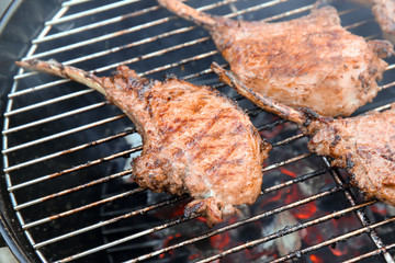 Cooking of appetizing juicy spare ribs outdoors