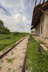 Abandoned railway track. Jungle in Mexico slowly recovers land. The station's roof is gone