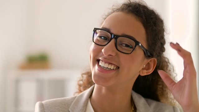 education, business and facial expression concept - face of happy smiling young african american woman in glasses