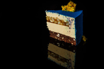 horizontal view of piece of cake on black background