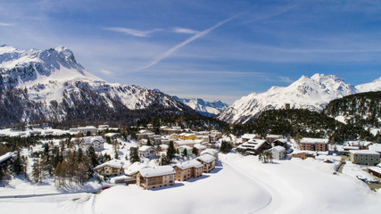 Alpine village, houses covered with snow. Winter season in Engadine (Maloja Pass)