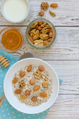 Healthy breakfast of muesli with nuts, honey and milk