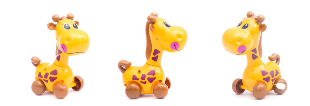 Three mechanical giraffe toy. Clockwork plastic toy isolated on white background.