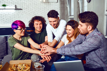 Friendship of young people. Meeting a group of friends in the apartment.