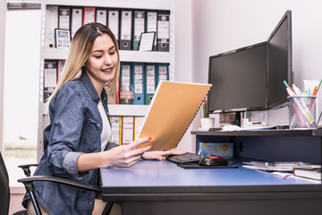  Business smiling woman holding files
