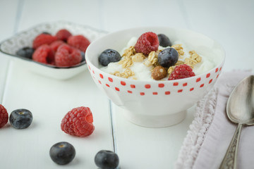 Healthy breakfast with berries, granola, yogurt parfait.