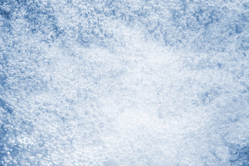 Fototapeta na wymiar Bubbles in water on blue background.
