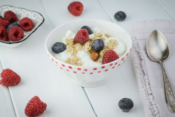 Healthy breakfast with berries, granola, yogurt parfait.