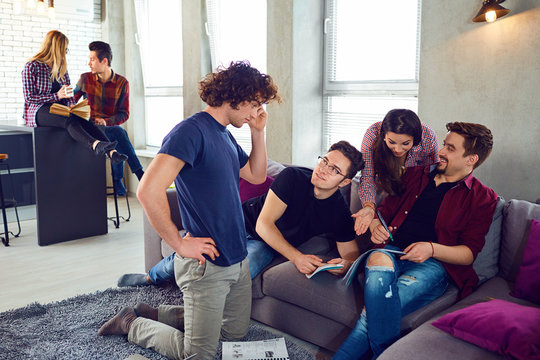 A group of young people students are discussed indoors.