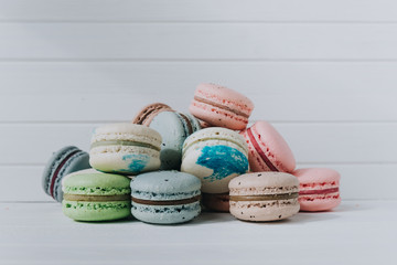 Bunch of multicolored macaroons or macaron on a white background, copy space.