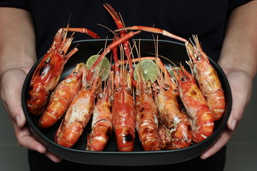 Streamed large fresh prawns served on Korean plate.