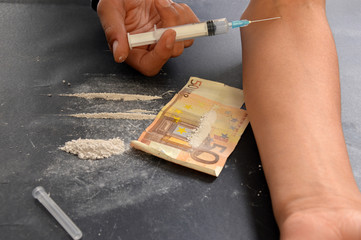 A person drugged while injecting a dose