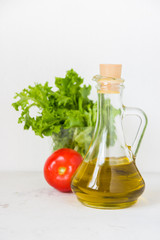 Olive oil, green salad lettuce and fresh tomato