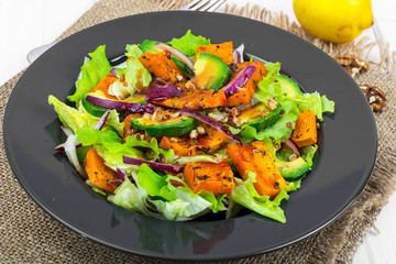 Delicious salad with avocado, pumpkin, greens