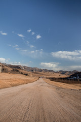 Sand road track outside country with mountain and blue sky