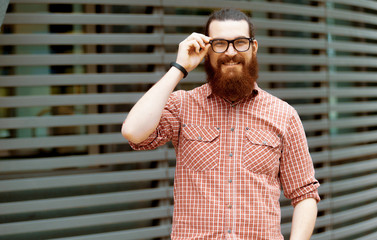 young guy with a beard and mustache with glasses posing on the street, fashion man, style, vintage style, retro men, handsome beard, outdoor portrait, close up