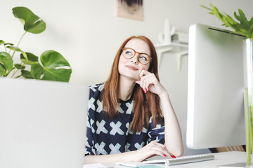 Cute young girl working on eyeglasses creating new project. Modern model of business woman.