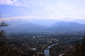 Skyline of French Alps. Comparing concept in French Alps. Small city and mountains above. Grenoble, France