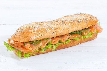 Sandwich whole grains baguette with smoked salmon fish on wooden board