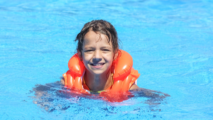 Pretty funny little girl in swimming pool