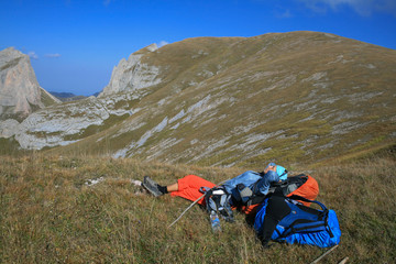 Young woman resting after lifting during a mountain hike