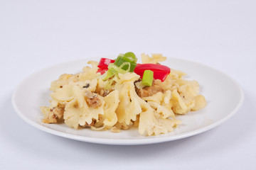 Wholemeal pasta baked with cabbage on a white