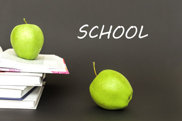 text school, two green apples, open books with concept