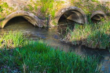 Concrete culvert pipe hole system draining sewage water. Environmental disaster.