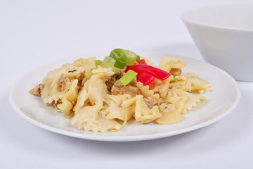 Wholemeal pasta baked with cabbage on a white