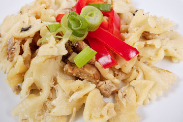 Wholemeal pasta baked with cabbage on a white