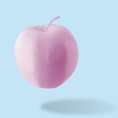 Pink apple on blue background. Minimal style. Food concept.