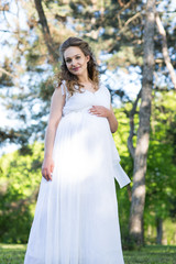 Fototapeta na wymiar Pregnant woman in a spring park