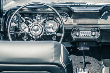 Close-up, detailed photo of the interior, dashboard, steering wheel and speedometer of a classic...