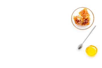 Apiary products. Honey in bowl and honeycomb on white background top view copy space