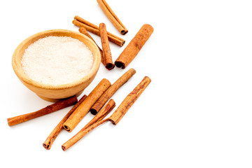 Cinnamon for cooking. Cinnamon sticks near bowl with sugar on white background copy space