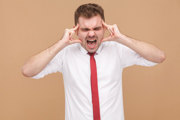Angry businessman have migraine and headache