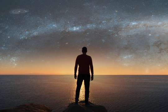 A man looks at the stars.  Elements of this image furnished by NASA.