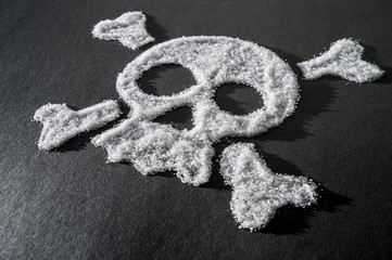 skull made of sugar, sugar crystals in the shape of a skull on a dark background, concept about the...