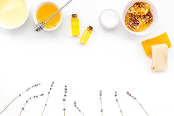 Homemade cosmetics with honey. Handmade soap, spa salt, cream on white background top view