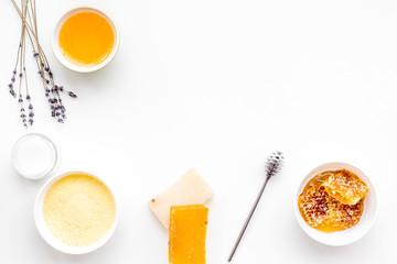 Homemade cosmetics with honey. Handmade soap, spa salt, cream on white background top view copy space